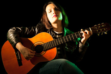 Obraz premium Woman Playing Classical Guitar in a Concert