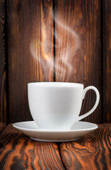 White cup with steaming hot drink
