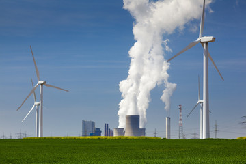 green energy against power plant - obrazy, fototapety, plakaty