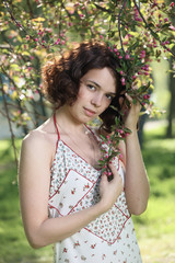 Portrait of the girl against a blossoming crab