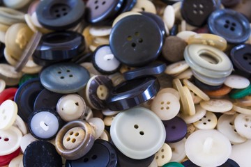 Many different sized colored and shaped buttons