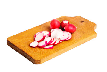 Fresh slised and whole radish on  cutting board