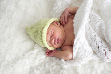 newborn baby with green hat