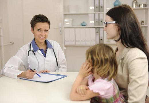 Pediatrician talking to mother and child