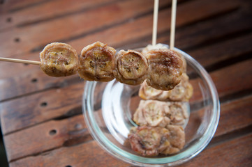 Thailand dessert, baked whole banana on stick and syrup topping