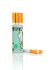 Cigarettes and banknotes on a white background