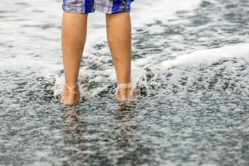 feet of boy at the beach