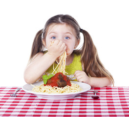 Beautiful girl eating pasta and meatballs with hands