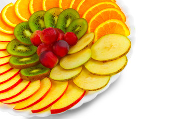 Salad apples oranges grapes kiwi fruit slices on a plate isolate