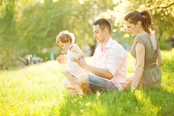 Fototapeta premium happy young family spending time outdoor on a summer day
