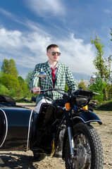 Fototapeta na wymiar Classy guy on a motorcycle with a sidecar