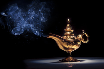 Magic Aladdin's Genie lamp on black with smoke - obrazy, fototapety, plakaty