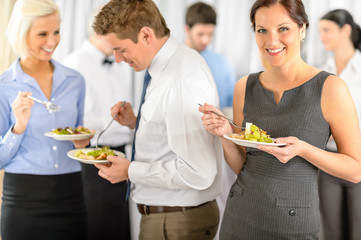 Smiling business woman during company lunch buffet