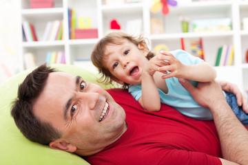 Father playing with toddler son