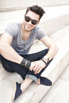 handsome male fashion model smiling, dressed casual - outdoor