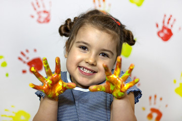Happy child plays in the paint at home during the renovation
