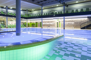 indoor swimming pool with green interior and illumination