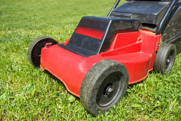 Fototapeta premium Lawnmower on grass