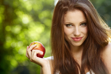 Woman with apple in garden