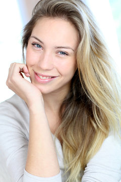 Portrait of beautiful blond woman relaxing in sofa