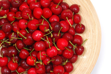 cherries close up in wooden plate