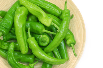 Green peppers in plate white background copy space.