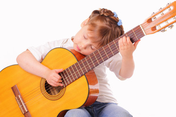 Fototapeta premium Little girl plays an old guitar