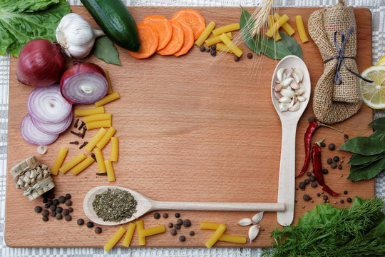 Frame made of spices and vegetables on a wooden table.
