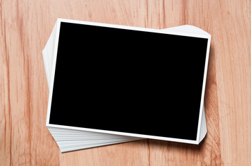 Stack photos on table. photos on wooden background