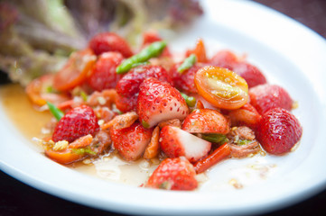 Strawberries spicy salad with chili, tomatoes and vegetables