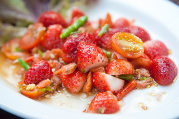 Strawberries spicy salad with chili, tomatoes and vegetables