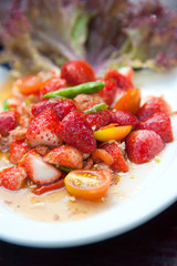 Strawberries spicy salad with chili, tomatoes and vegetables