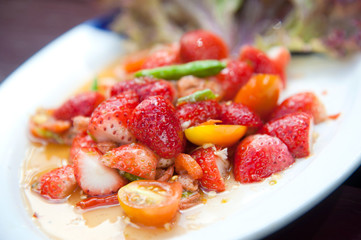 Strawberries spicy salad with chili, tomatoes and vegetables