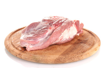 Raw meat on a wooden board isolated on white