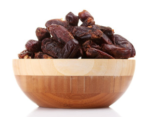delicious dried dates in wooden bowl isolated on white