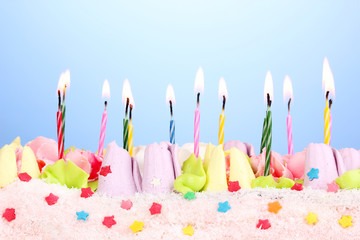 Birthday cake with candles on blue background