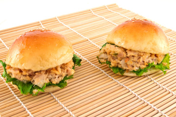 Two fresh burger with tuna on a mat