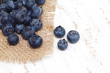 blueberry on sackcloth on wooden table