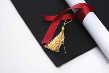 mortar board and the roll of diploma