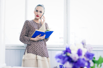 Brunette girl with book and phone