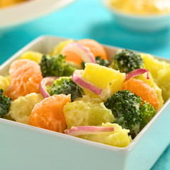 Potato, broccoli, mandarin and onion salad with mayonnaise