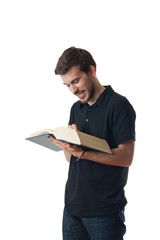 Man reading from a large book and smiling