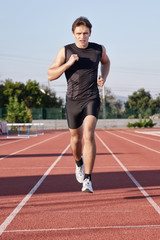 A young man run a hundred meters on the treadmill.