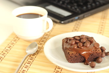 chocolate cake and a coffeecup lab top