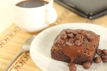 chocolate cake and a coffeecup lab top