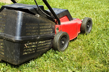 Fototapeta premium Lawnmower on grass