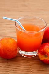 fresh juice in a glass and peaches