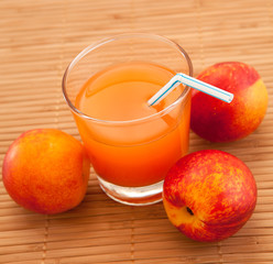 fresh juice in a glass and peaches