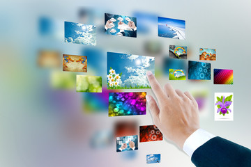 men hand using touch screen interface with pictures in frames