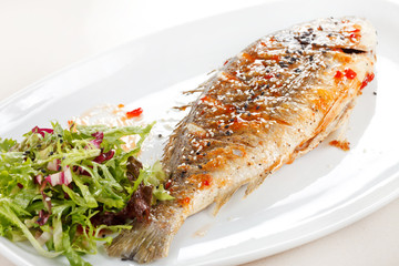 fried fish with fresh herbs and lemon